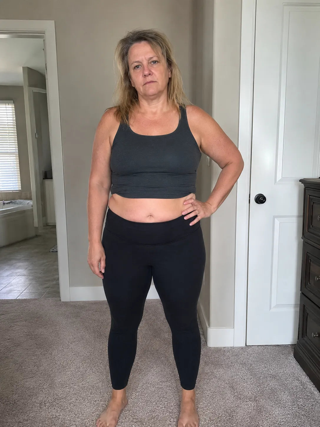 Woman standing indoors in black outfit